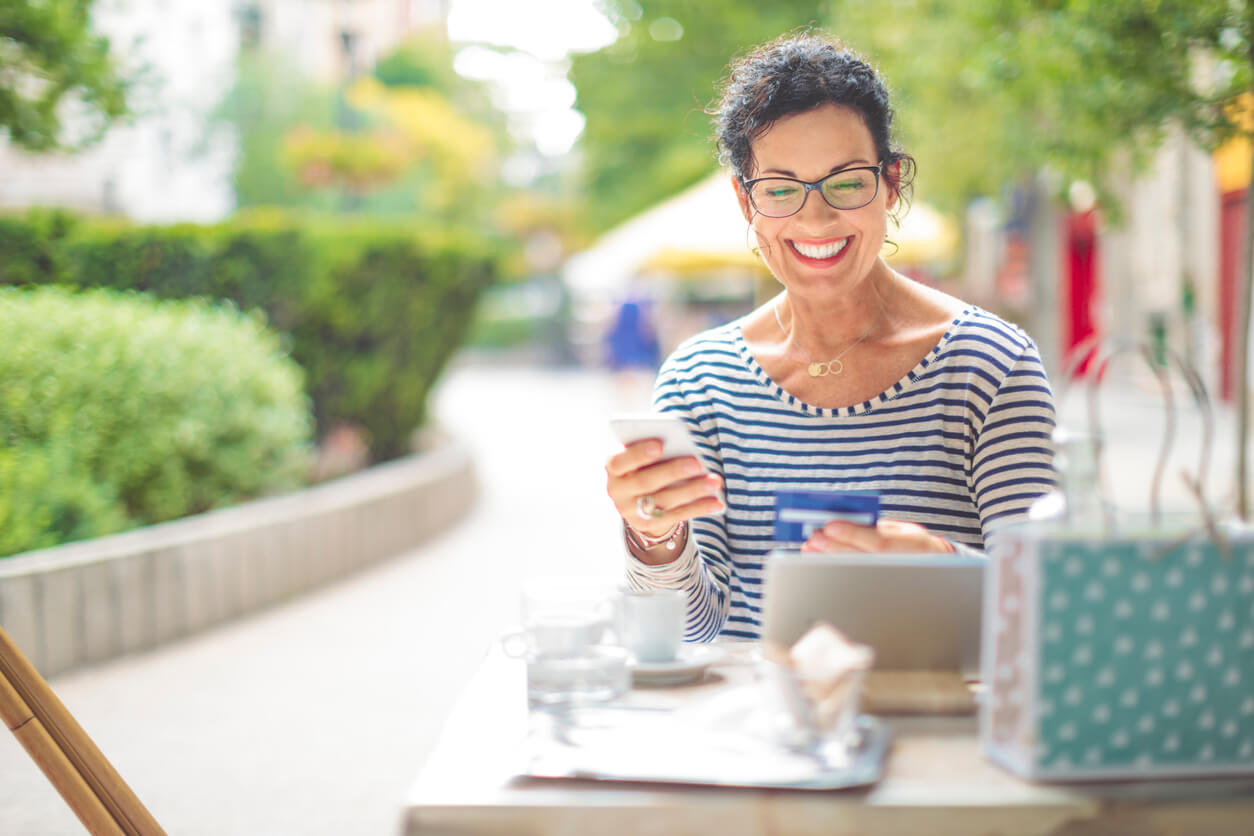 Woman Making A Second Purchase Outside Of A Business